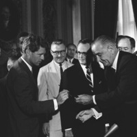 Thumbnail for President Lyndon B. Johnson handing a signing pen to Senator Robert F. Kennedy at the signing ceremony for the Voting Rights Act 