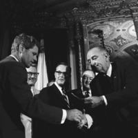 Thumbnail for President Lyndon B. Johnson handing a signing pen to Senator Robert F. Kennedy at the signing ceremony for the Voting Rights Act