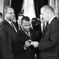 Thumbnail for President Lyndon B. Johnson handing a signing pen to John Lewis at the signing ceremony for the Voting Rights Act